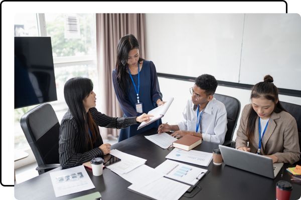 Marketing team reviewing campaign performance reports together